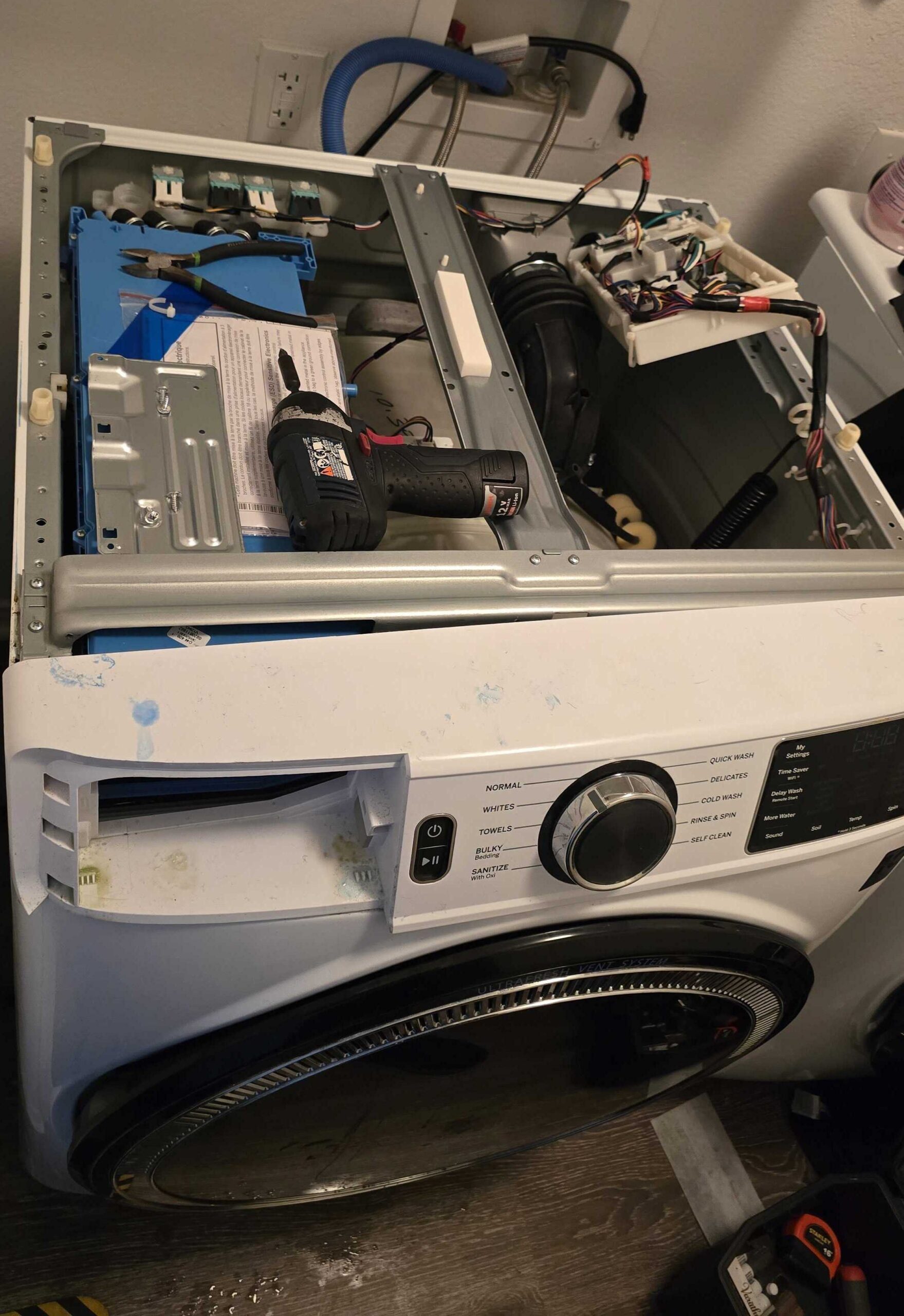 Technician fixing washing machine